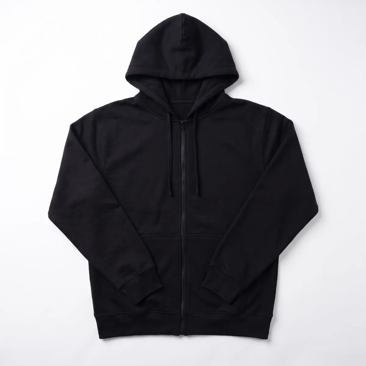 Black full-zip hoodie shown blank, then with white VELLORA embroidery. The mark is a fictional sample.